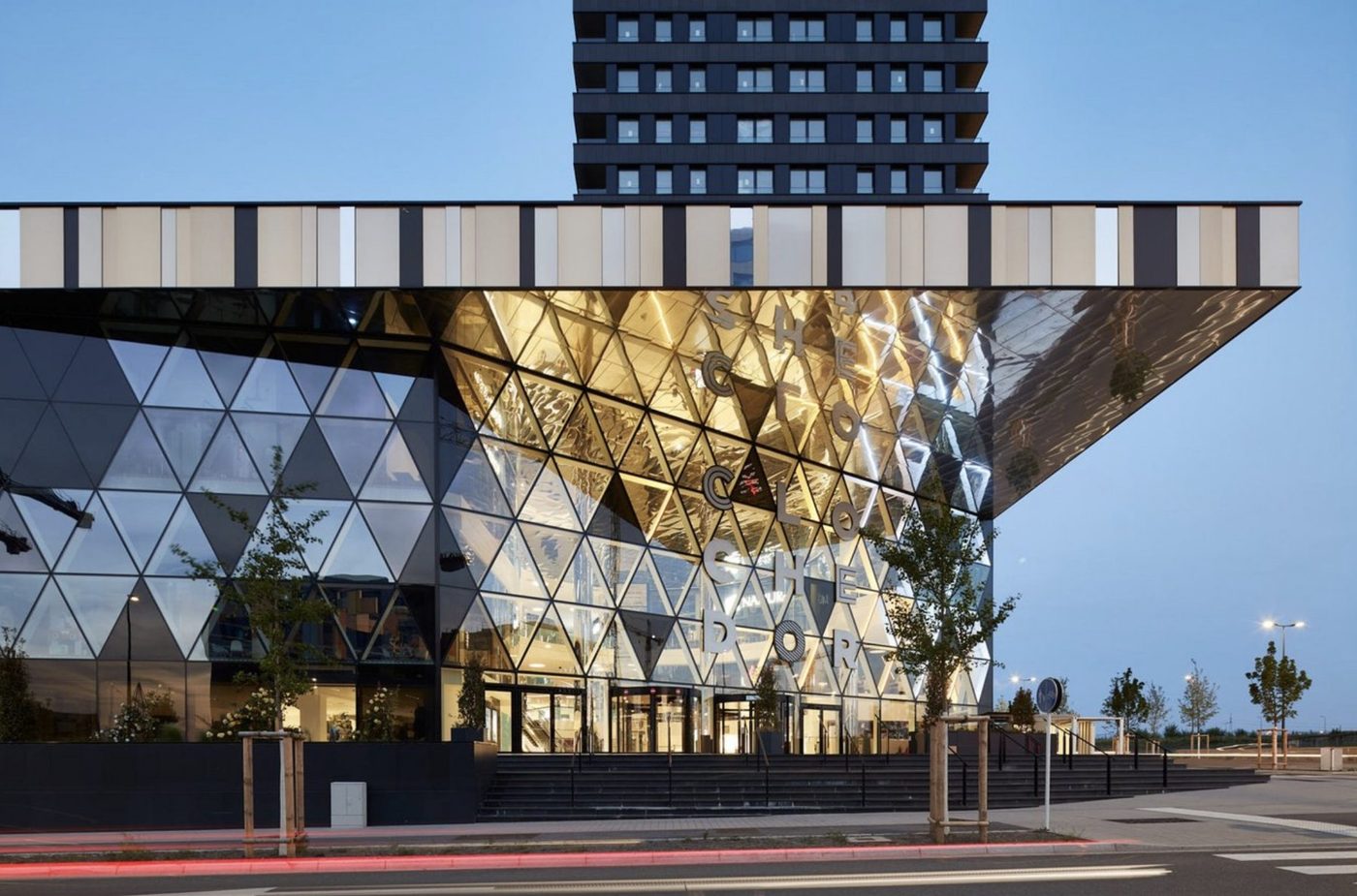 Completed building with triangulated glass façade